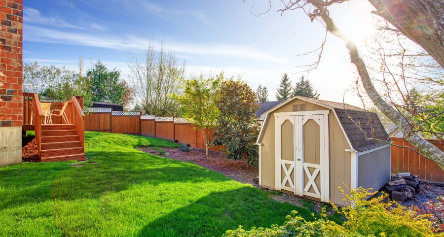 Fenced backyard with storage shed in Dallas